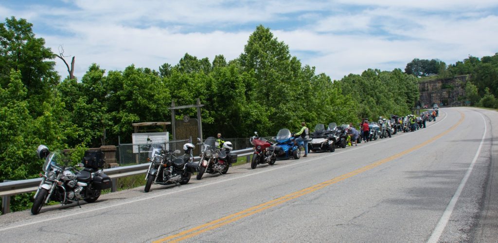 Motorcycles lined up along a road at the James River, Missouri State Rally 2021